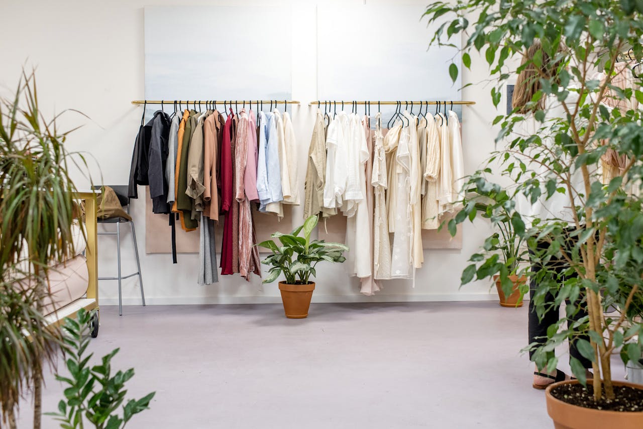 About Chic fashion boutique showcasing vibrant clothing collection with lush indoor plants.