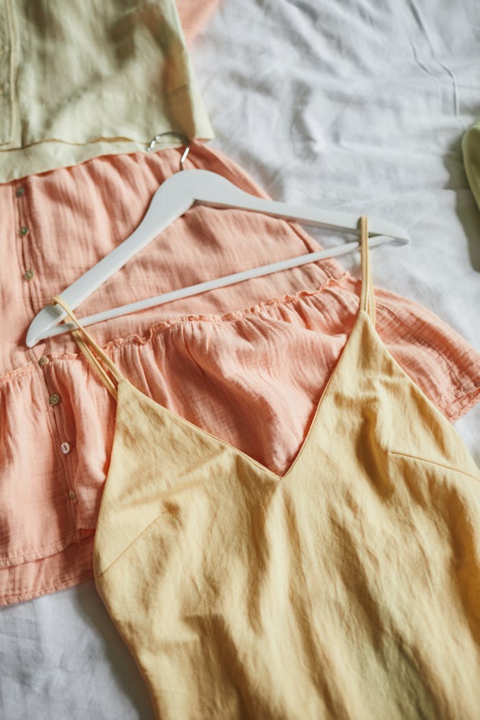 About Close-up of stylish pastel dresses on hangers, ideal for summer fashion inspiration.